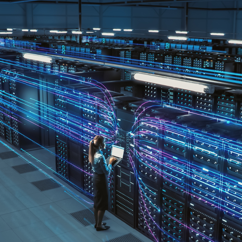 A woman in front of a server room, surrounded by lines of data, managing the digital infrastructure.
