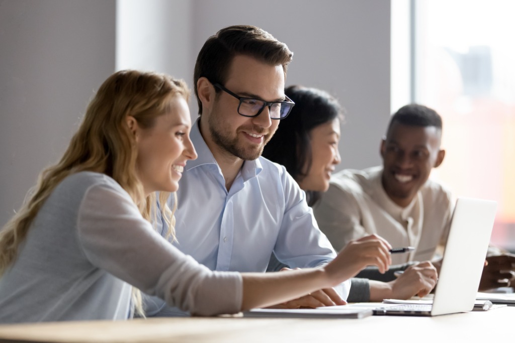 Employees working on laptop together